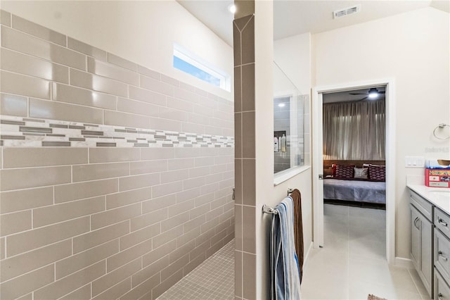 bathroom featuring tile patterned flooring, vanity, ceiling fan, and walk in shower