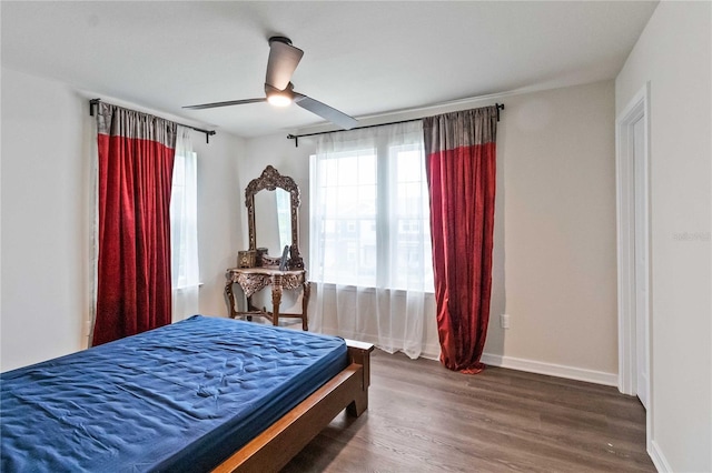 bedroom with ceiling fan and dark hardwood / wood-style floors