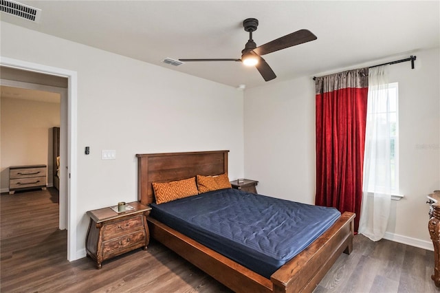 bedroom with ceiling fan and dark wood-type flooring