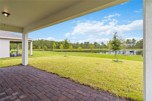 view of yard featuring a water view and a patio