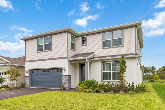 front of property featuring a garage and a front yard