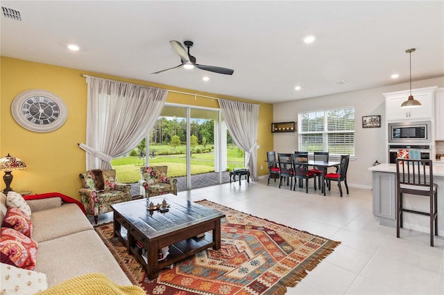 living room with light tile patterned floors and ceiling fan