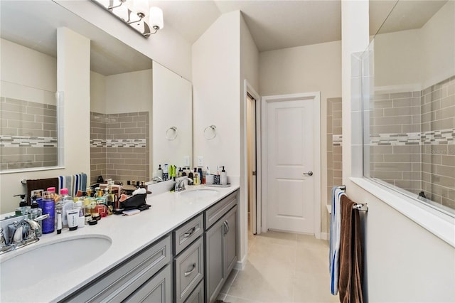 bathroom featuring tile patterned flooring, vanity, and a shower