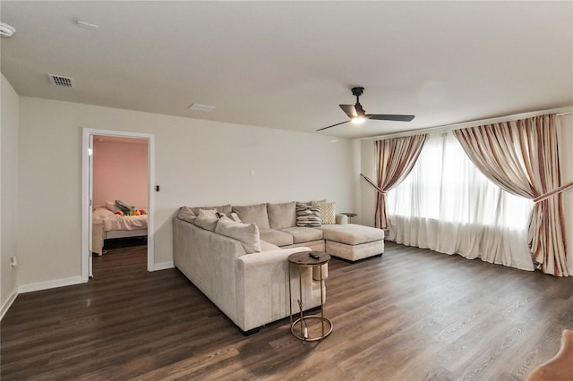 living room featuring dark hardwood / wood-style flooring and ceiling fan