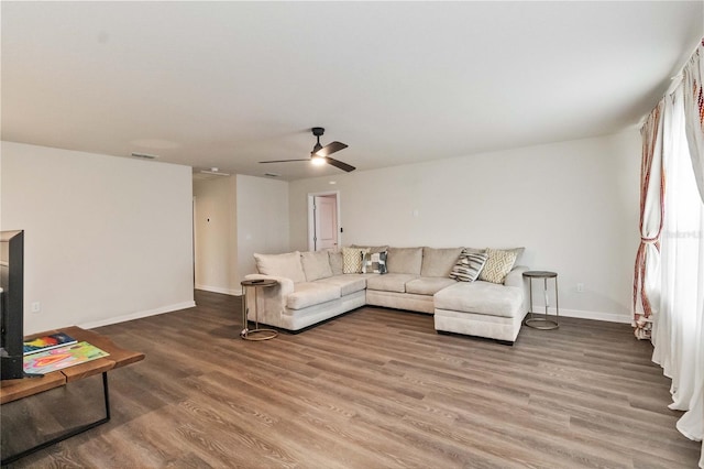 living room with hardwood / wood-style flooring and ceiling fan