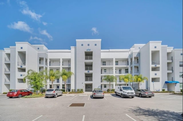 view of property featuring uncovered parking