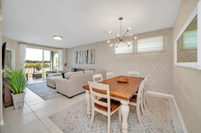 dining room featuring baseboards, a notable chandelier, wallpapered walls, and light tile patterned floors