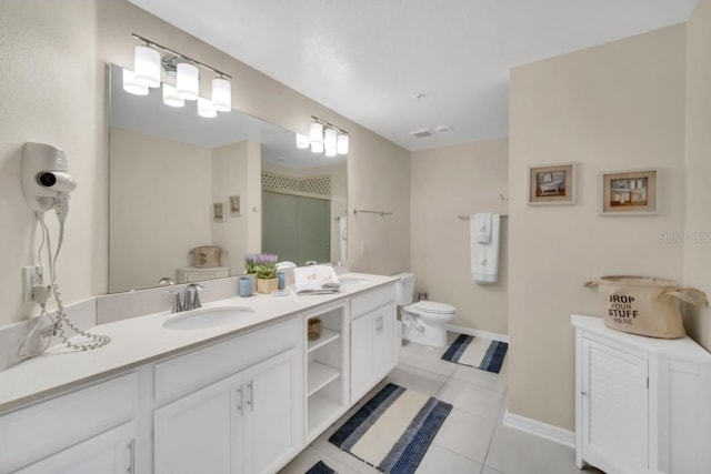 bathroom with tile patterned flooring, toilet, and double sink vanity