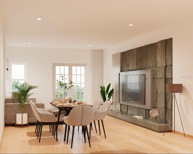 dining space featuring light hardwood / wood-style floors and a healthy amount of sunlight