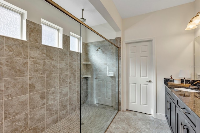 bathroom featuring vanity and tiled shower