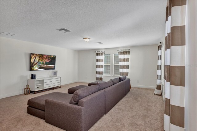 living room featuring carpet floors, visible vents, a textured ceiling, and baseboards