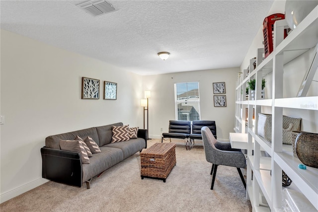 living room featuring carpet and a textured ceiling