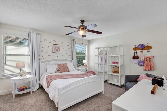 bedroom featuring baseboards, carpet, a ceiling fan, and a textured ceiling