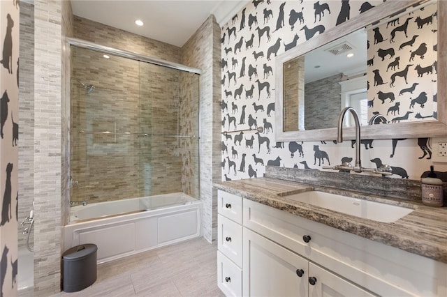 bathroom with vanity and combined bath / shower with glass door