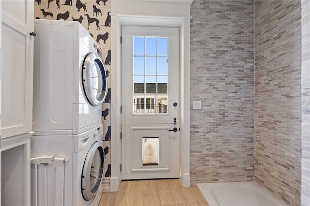 laundry room with stacked washer / dryer