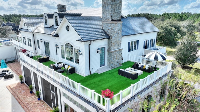 exterior space with a yard, a sunroom, and an outdoor living space