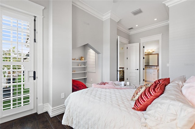 bedroom featuring ornamental molding, ensuite bath, and dark hardwood / wood-style floors