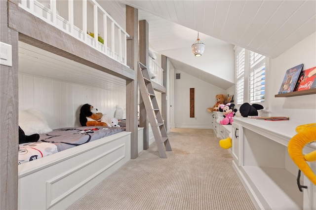 bedroom with light colored carpet and lofted ceiling