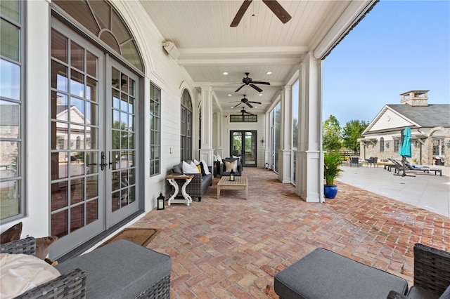 sunroom with french doors, wooden ceiling, ceiling fan, and beamed ceiling