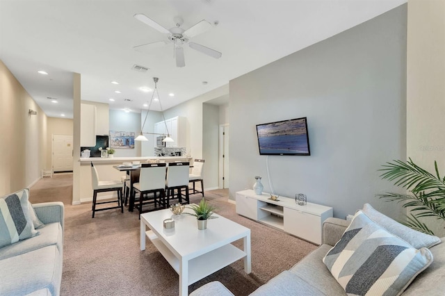 carpeted living room featuring ceiling fan