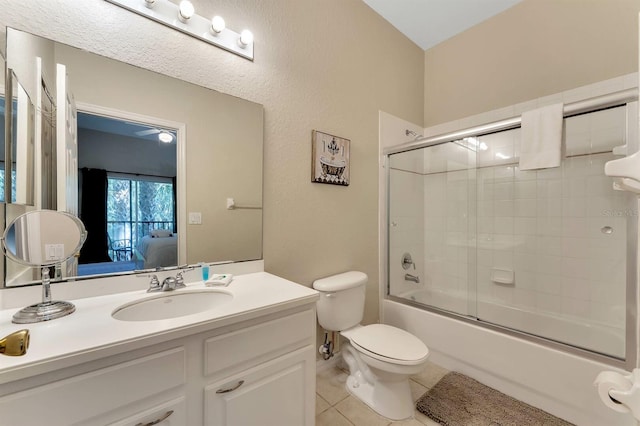 full bathroom with vanity, shower / bath combination with glass door, toilet, and tile patterned floors