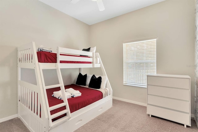 carpeted bedroom featuring multiple windows and ceiling fan