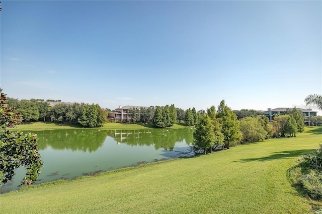 surrounding community featuring a water view and a yard