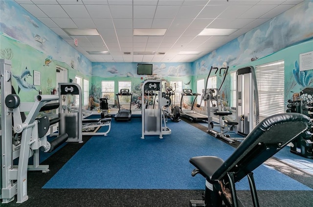 gym with carpet flooring and a paneled ceiling