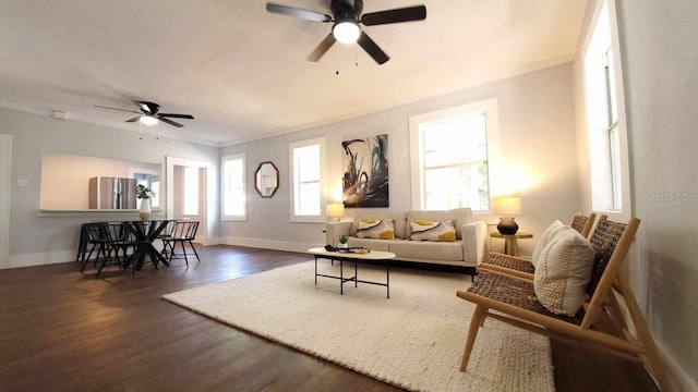 living room with a healthy amount of sunlight, ceiling fan, and dark hardwood / wood-style floors