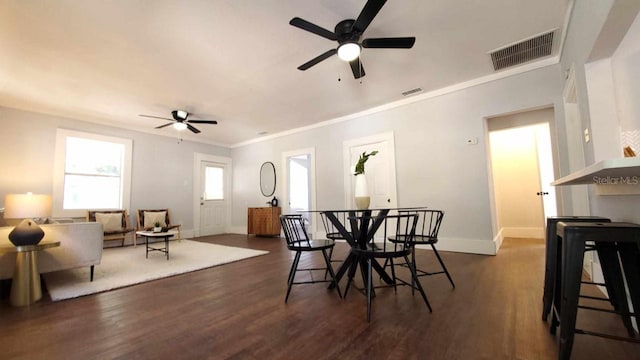 dining room with dark wood-type flooring, ceiling fan, and a wealth of natural light