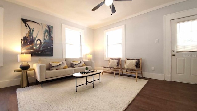 living room featuring dark hardwood / wood-style floors, ceiling fan, and a wealth of natural light