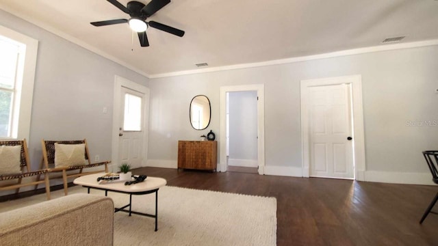 living room featuring ornamental molding, ceiling fan, and dark wood-type flooring