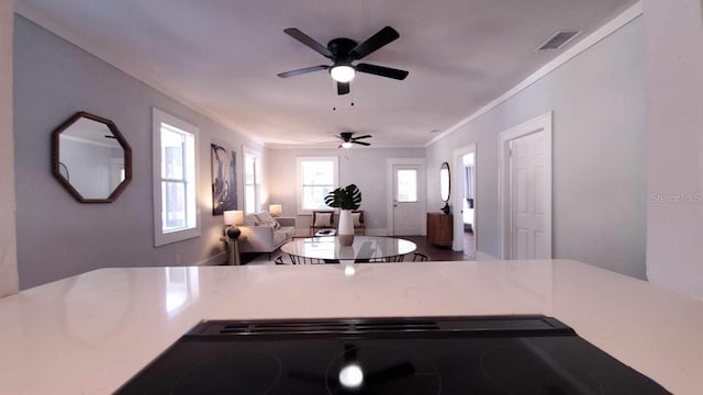 kitchen featuring ceiling fan and ornamental molding