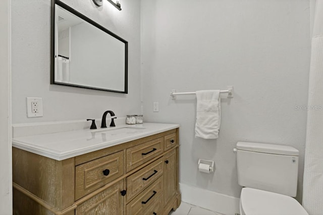 bathroom with vanity, tile floors, and toilet