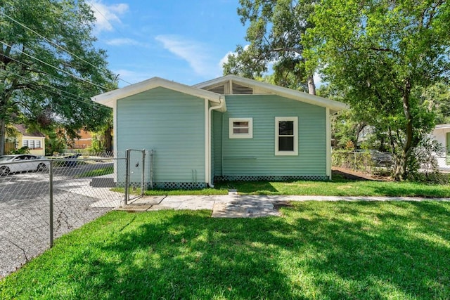 rear view of house with a lawn