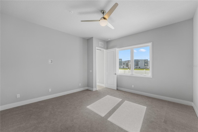 empty room with light carpet and ceiling fan