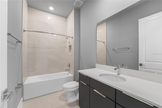 full bathroom featuring vanity, tile patterned flooring, toilet, and tiled shower / bath combo