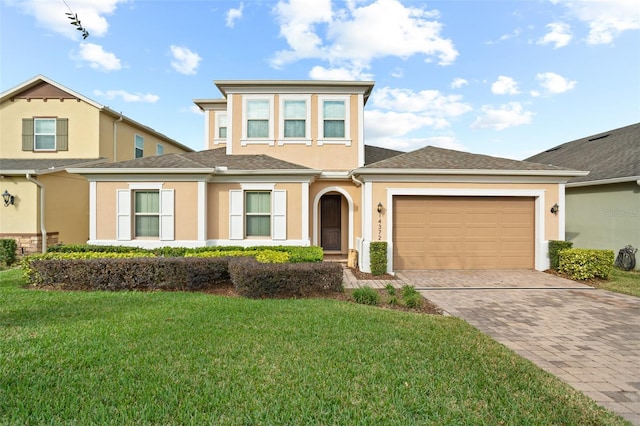 14372 Sunbridge Cir, Winter Garden, FL 34787 - view of front of house featuring stucco siding, driveway, a garage, a front lawn, and a shingled roof