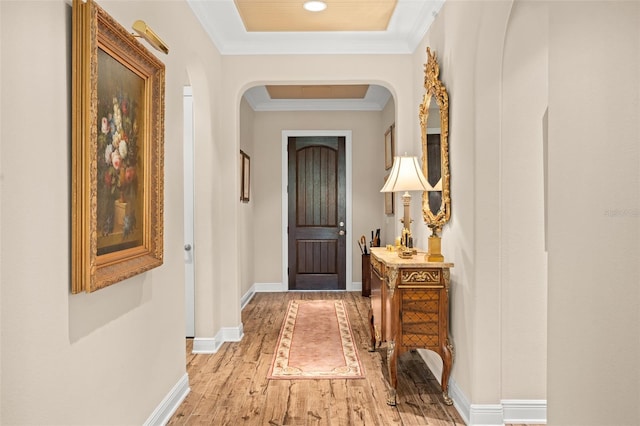 14372 Sunbridge Cir, Winter Garden, FL 34787 - hallway featuring arched walkways, light wood-style flooring, and ornamental molding