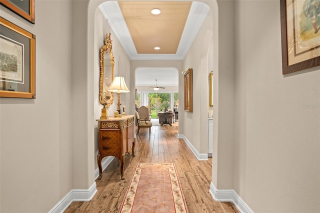 14372 Sunbridge Cir, Winter Garden, FL 34787 - hallway featuring light wood finished floors, arched walkways, recessed lighting, and crown molding
