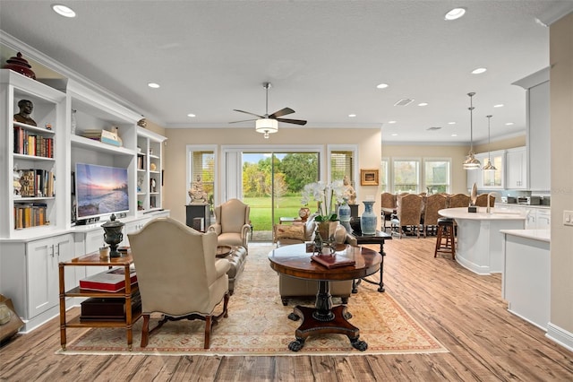 14372 Sunbridge Cir, Winter Garden, FL 34787 - living room featuring light wood finished floors, ornamental molding, a ceiling fan, and recessed lighting