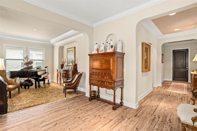 living area with crown molding and light hardwood / wood-style floors