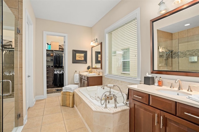 14372 Sunbridge Cir, Winter Garden, FL 34787 - full bath featuring a stall shower, vanity, a tub with jets, tile patterned floors, and a walk in closet