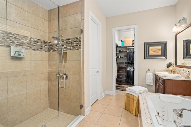 bathroom featuring plus walk in shower, vanity, and tile patterned flooring