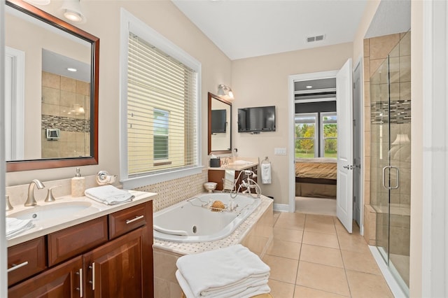 bathroom featuring tile patterned flooring, vanity, and plus walk in shower