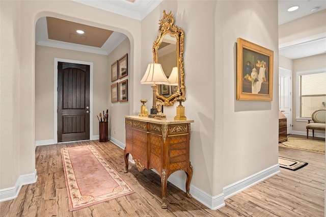 14372 Sunbridge Cir, Winter Garden, FL 34787 - foyer entrance with crown molding, light wood-style floors, arched walkways, and recessed lighting