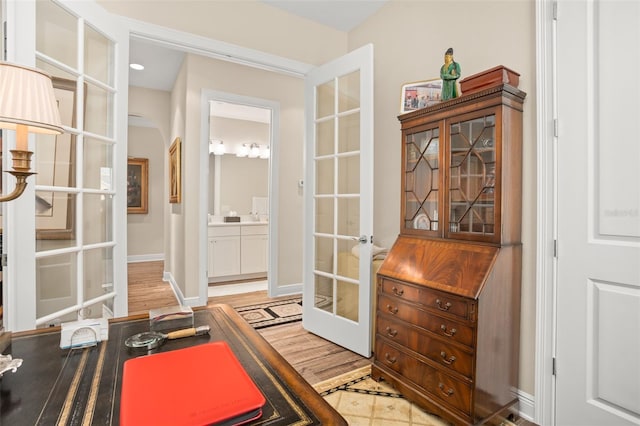 14372 Sunbridge Cir, Winter Garden, FL 34787 - office area featuring french doors, arched walkways, and light wood-style floors