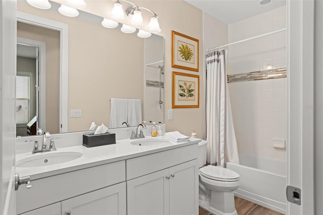 full bathroom featuring wood-type flooring, vanity, toilet, and shower / bath combo