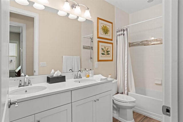 14372 Sunbridge Cir, Winter Garden, FL 34787 - full bath with double vanity, shower / bath combo with shower curtain, and wood finished floors
