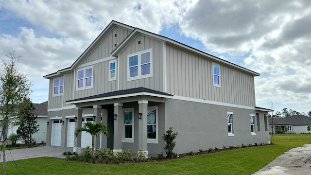 view of front of home featuring a garage and a front lawn